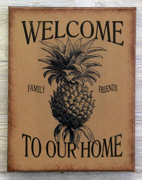 A canvas print with a pineapple design and the text 'Welcome to our home'.