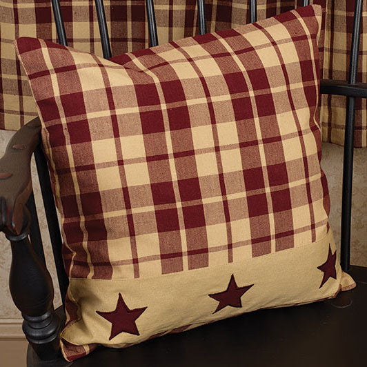 Plaid pillow with star patterns on a chair