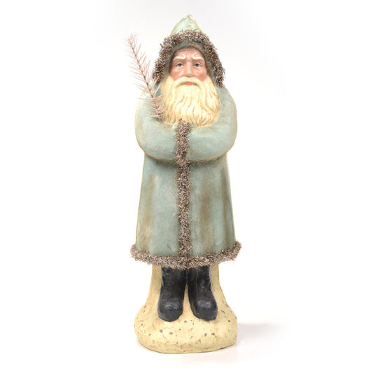 Soft blue colored santa figure with silver details on coat on white background.