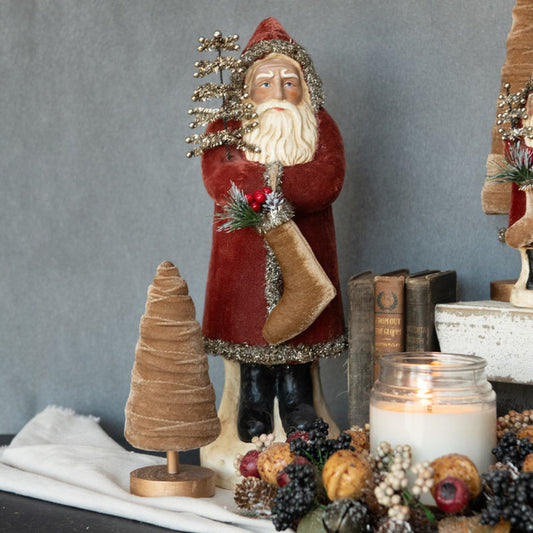 Russet velvet belsnickel with books and candle in background.