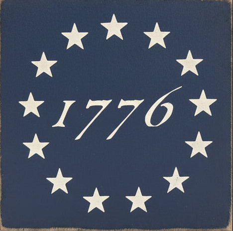 Decorative sign with '1776' and stars on a wooden background