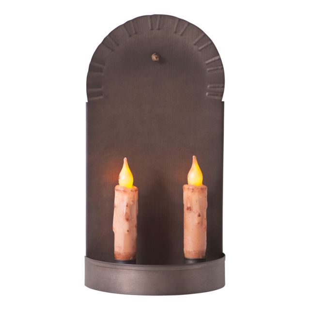 A black metal candle sconce with two candles lit, showing a warm glow.