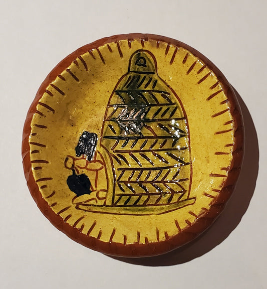 Ceramic tile with a design of a bee and honeycomb on a yellow background