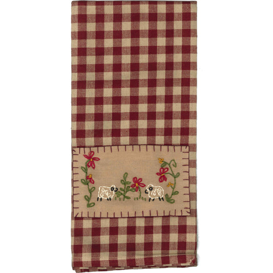 A red and white checkered hand towel with embroidered sheep on the front.