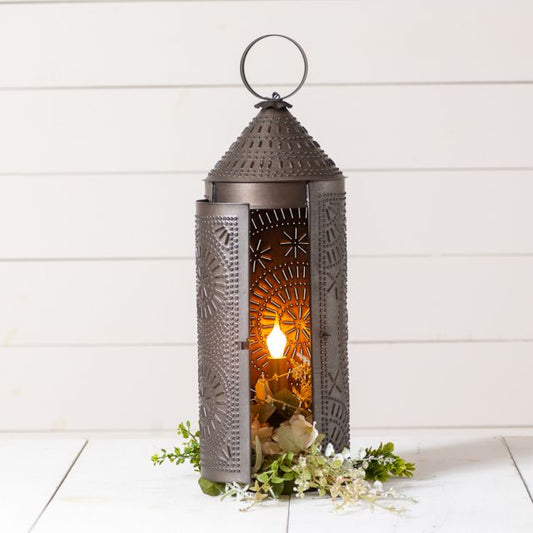 Decorative lantern with a light inside on a white wooden background