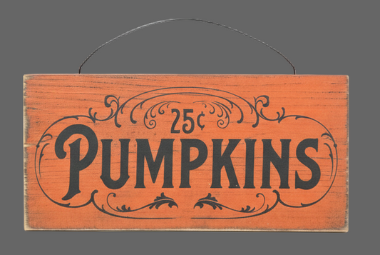 Wooden sign with '25c Pumpkins' text on a gray background