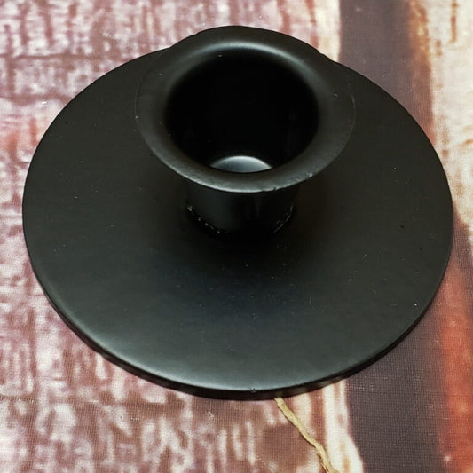 Candle cup sitting on textured surface