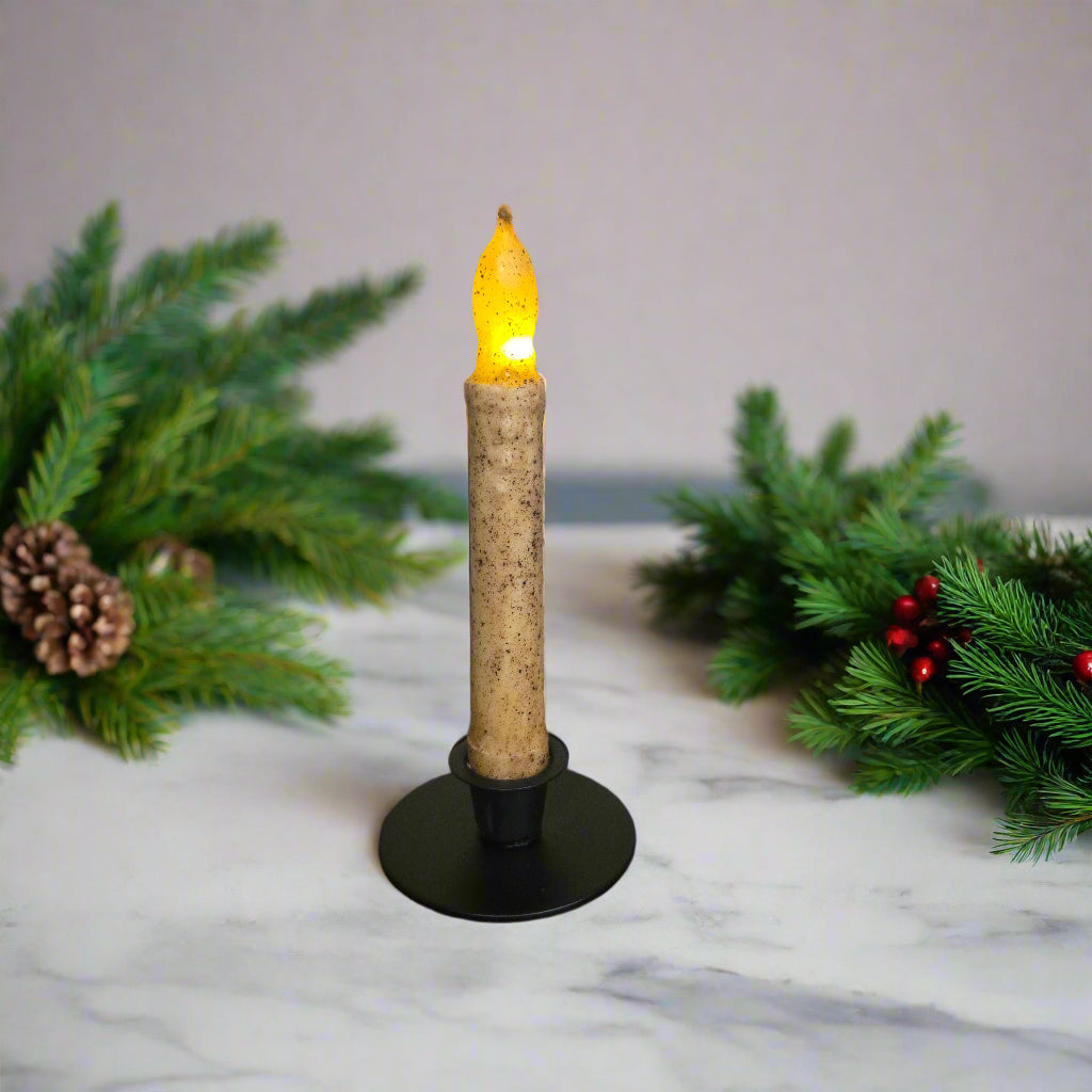 Flickering candle light on a wooden surface