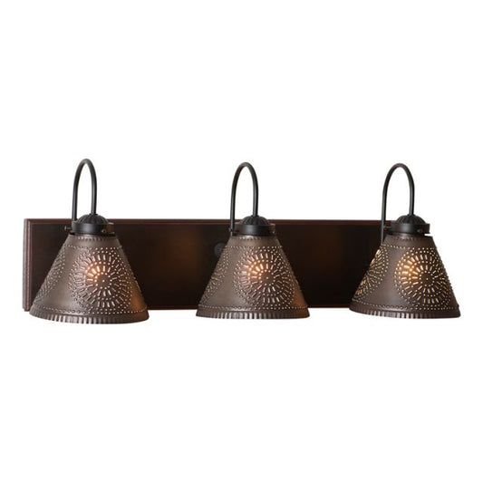 A rustic black three-light vanity light with hand-painted wooden back and kettle black tin shades.