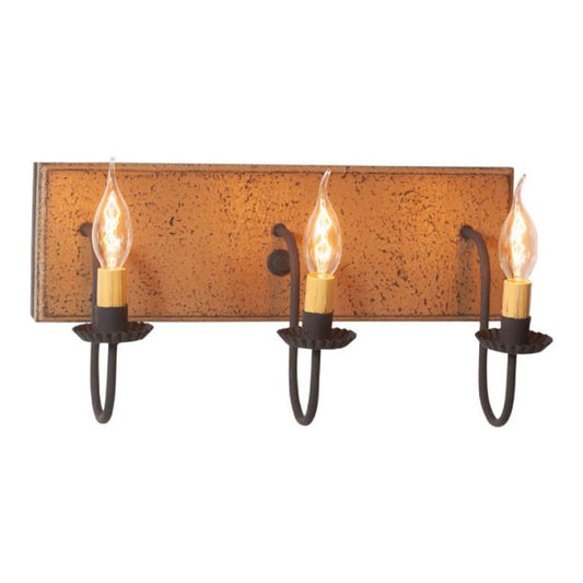 A pearwood painted wooden vanity light with black textured arms and three E12/Candelabra sockets with visible bulbs.