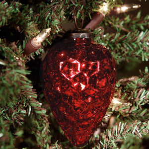 A 3-inch red cone-shaped mercury ornament hanging from a Christmas tree, with a sophisticated and elegant appearance.
