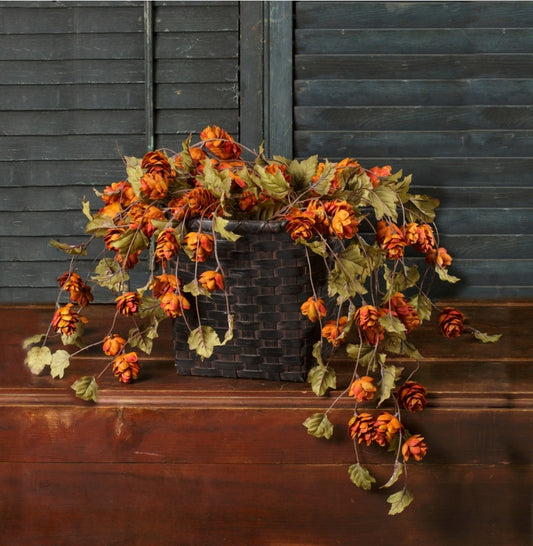 Orange color florals in basket in from of old shutters