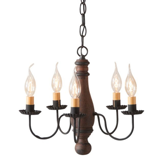 A compact, well-proportioned wooden chandelier with a Hartford Pumpkin with Black Stripes finish, featuring textured black arms with crimped pans and E12/Candelabra sockets.