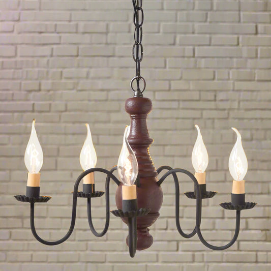 Chandelier with wooden base and black metal arms on a white background