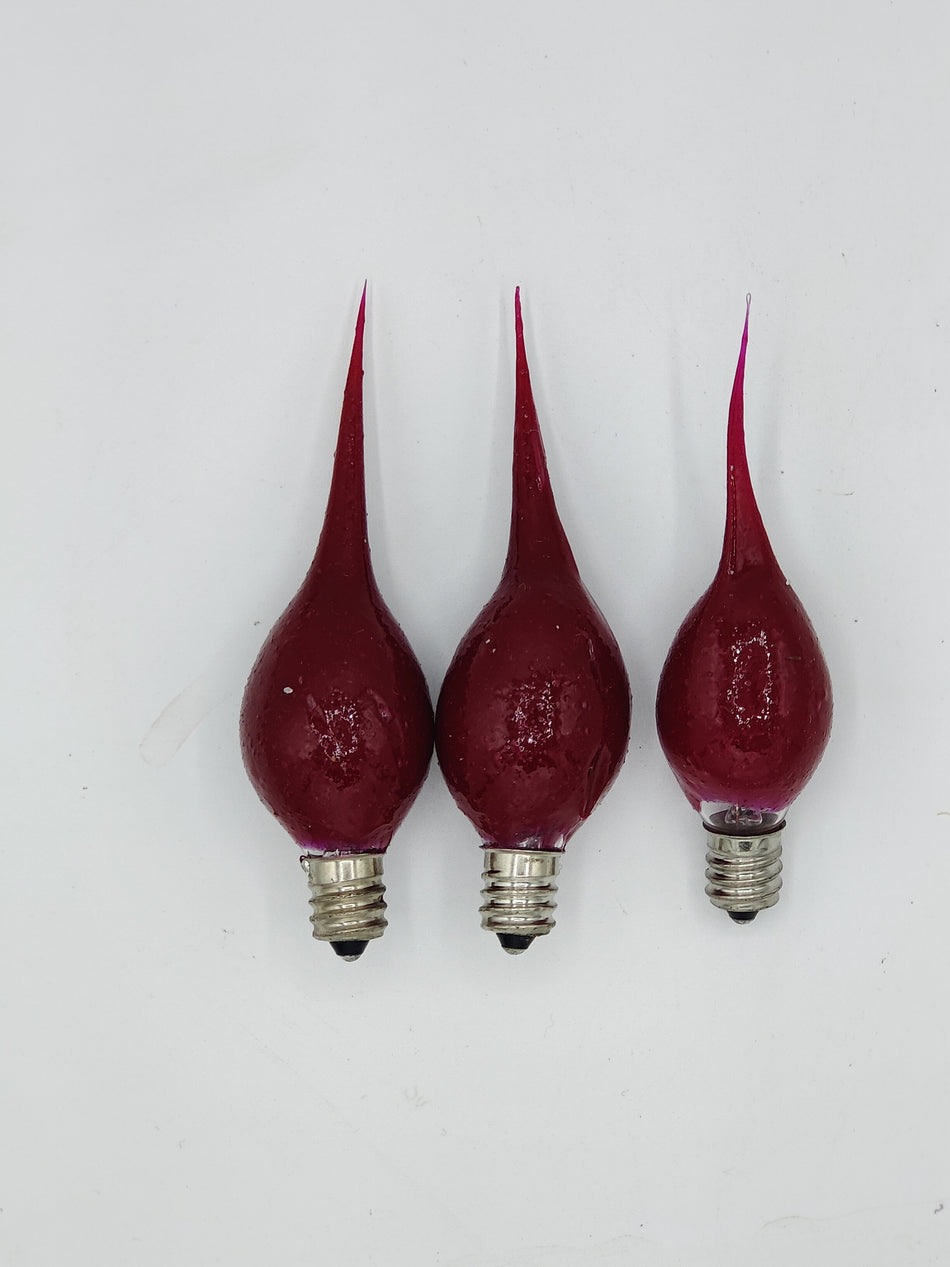 Three red silicone bulbs with a pointed end and E26 base, designed to be used in household lighting.