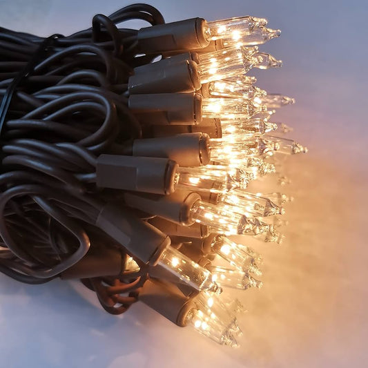 A bundle of brown wire lights with clear bulbs and brown cords, illuminated and ready for use.