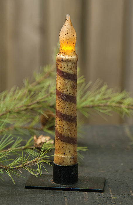 6 inch burnt ivory candy cane timer taper candle in black taper holder with greenery