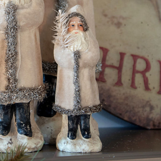 8 inch velvet ivory belsnickel with tin sign in the background.