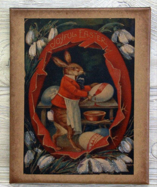 Canvas print with a bunny painting Easter eggs inside a large cracked egg