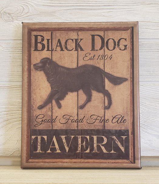 A canvas print featuring a black dog with the text 'Black Dog' and 'Good Food Fine Ale' in a vintage style font, on a wooden background.