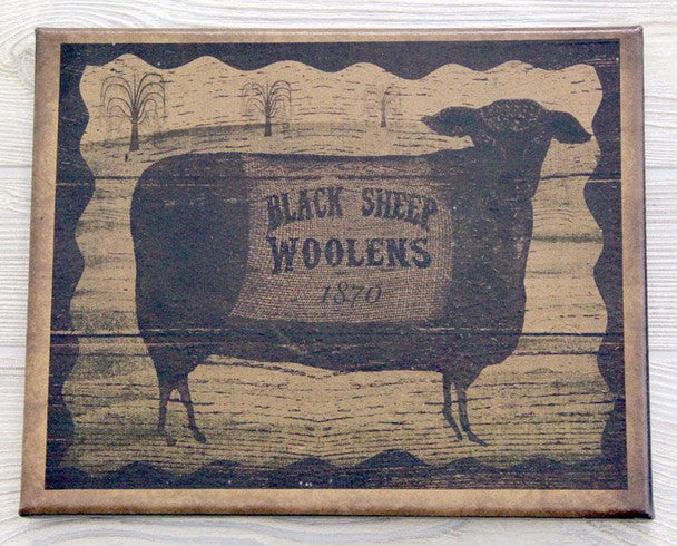 A canvas print featuring a vintage-style image of a black sheep with the text 'Black Sheep Woolens 1777' in a rural landscape background.