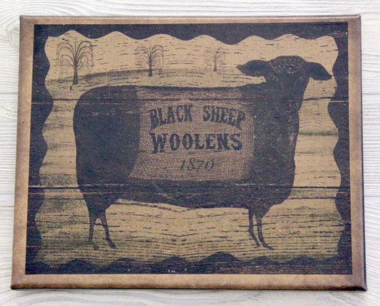 A canvas print featuring a vintage-style image of a black sheep with the text 'Black Sheep Woolens 1777' in a rural landscape background.