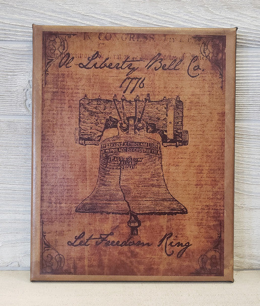 A canvas print featuring a detailed illustration of the Liberty Bell with a vintage-style font and design, titled 'A Liberty Bell Co. 1776'.