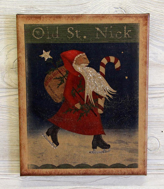 A canvas print featuring the figure of Old Saint Nick, also known as Santa Claus, with a sack full of gifts, set against a blue background with stars and holly. The text 'OLD ST.