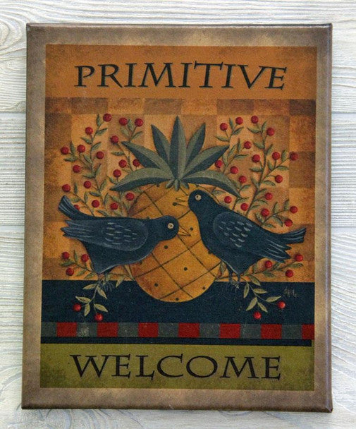 A canvas print titled 'PRIMITIVE WELCOME' featuring a pineapple design with birds and green leaves.
