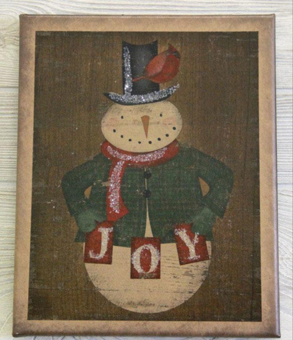 Canvas print depicting a snowman dressed in a top hat with a cardinal sitting on his hat