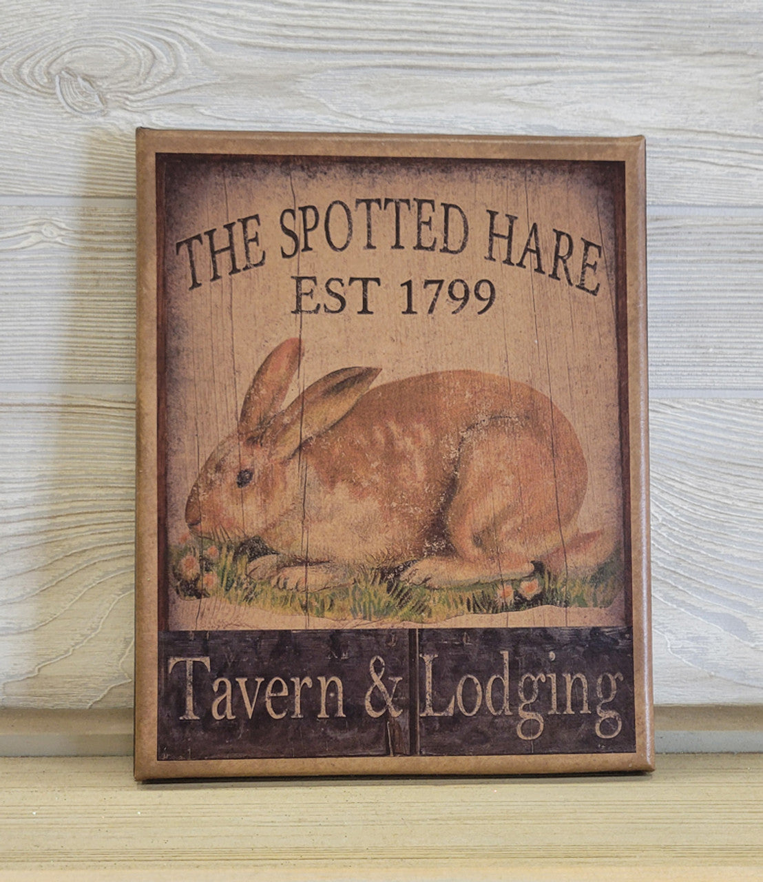 A canvas print with a spotted hare design, featuring text 'THE SPOTTED HARE EST 1799 Tavern & Lodging' at the bottom.