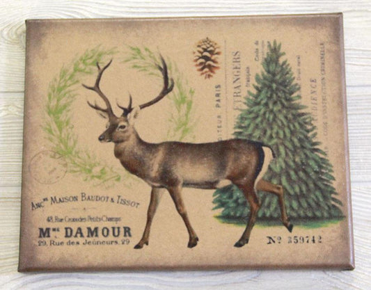 A canvas print featuring a vintage-style illustration of a deer with a full rack of antlers, accompanied by a pine tree and text, on a wooden background.