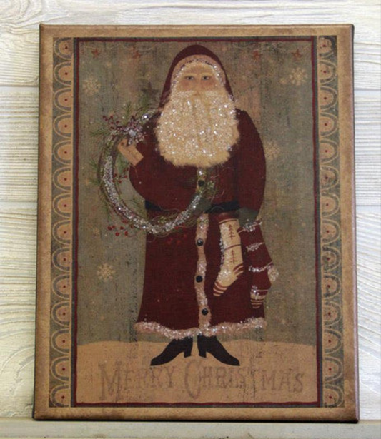 Canvas print of a Santa holding stockings and a wreath with the words "Merry Christmas" lightly printed below him