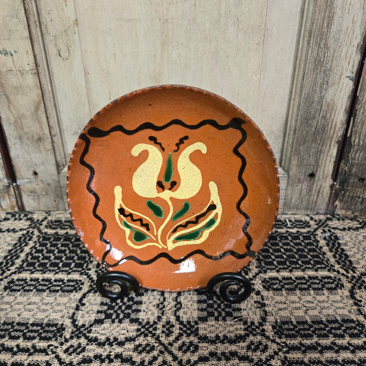 Redware plate featuring a tulip inside a postage stamp border