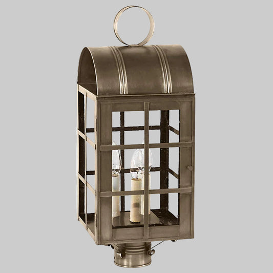 Bronze outdoor lantern with glass panels on a gray background