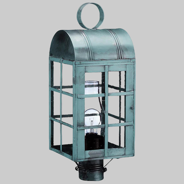 Vintage-style metal lantern with glass panels on a gray background
