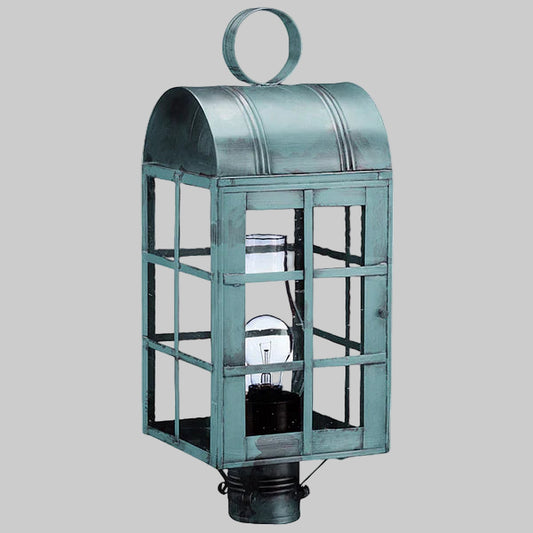 Vintage-style metal lantern with glass panels on a gray background