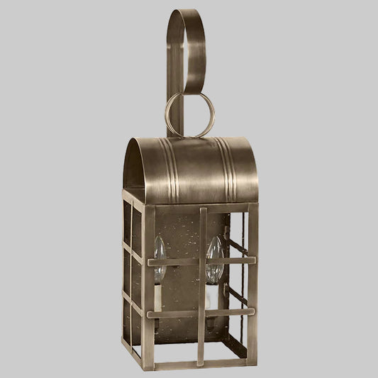 Bronze wall-mounted lantern with two glass bulbs on a white background