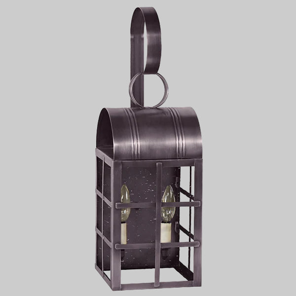 Decorative metal wall lantern with two glass bulbs on a gray background
