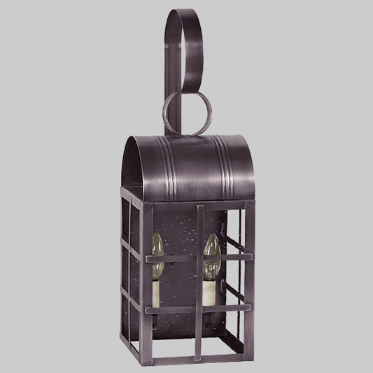Decorative metal wall lantern with two glass bulbs on a gray background