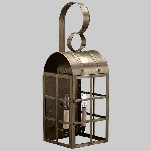 Decorative metal lantern with glass panels on a gray background