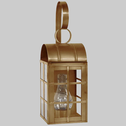 Gold lantern with a clear glass shade on a gray background