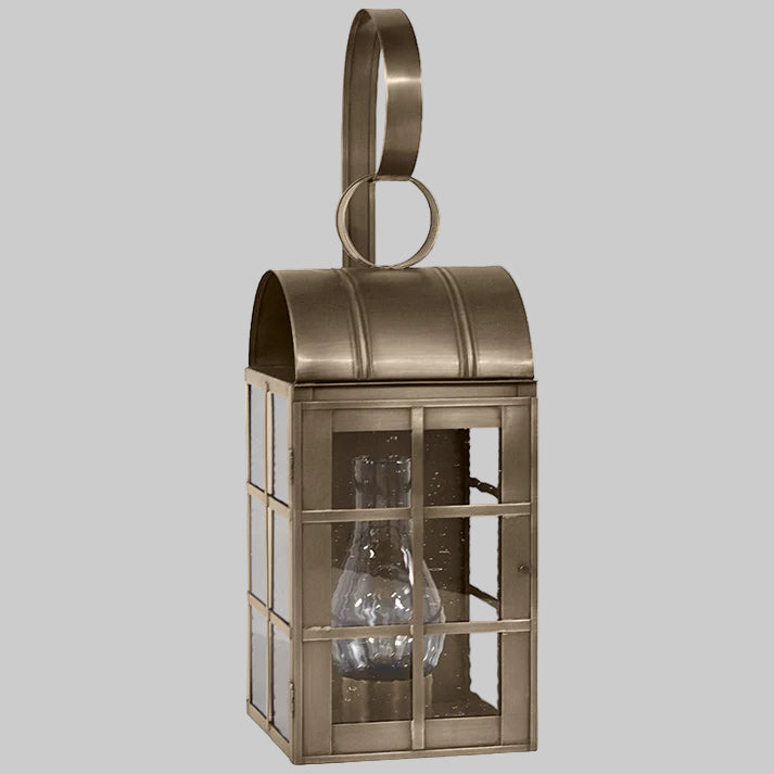 Bronze lantern with glass panels on a gray background