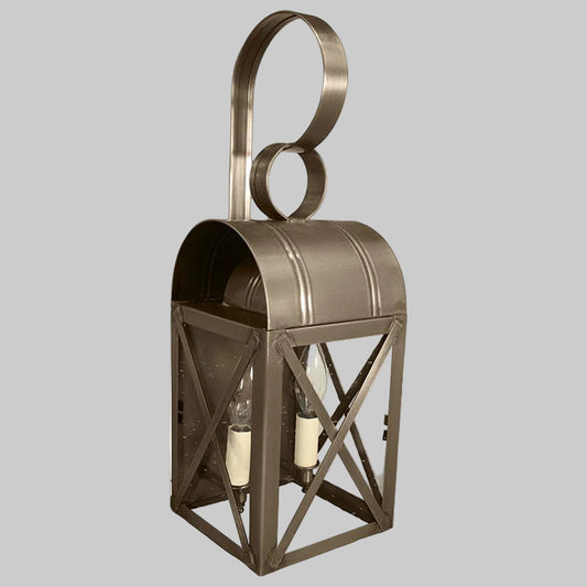 Bronze outdoor wall lantern with glass panels on a gray background