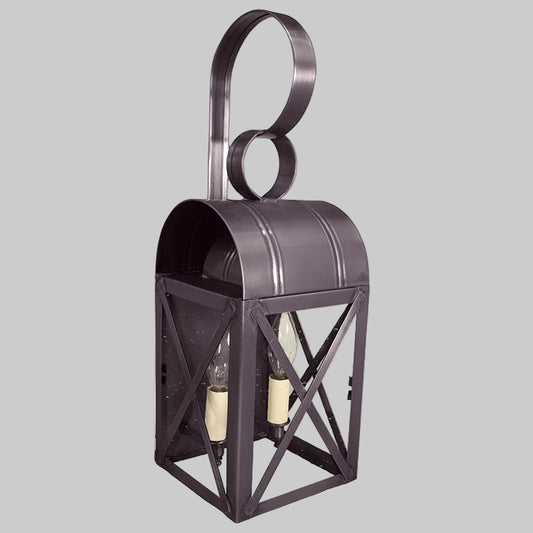 Decorative wall lantern with metal frame and glass panels on a gray background
