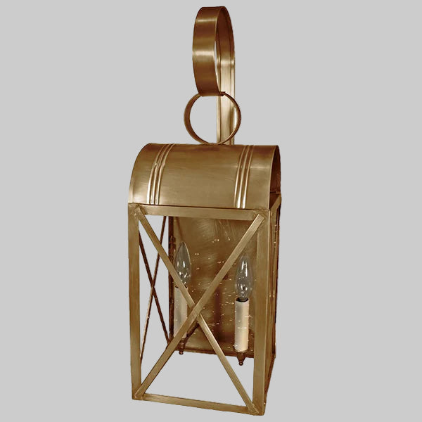 Gold wall-mounted lantern with a white bulb on a gray background