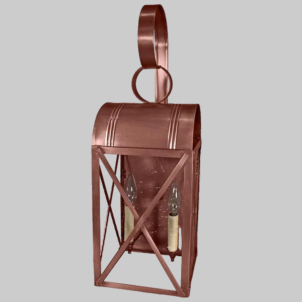 Copper wall lantern with a gray background