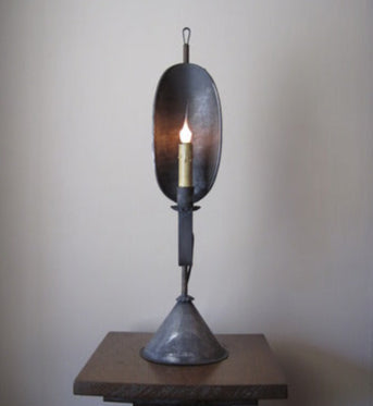 Decorative lamp with a unique design on a wooden stand against a plain background