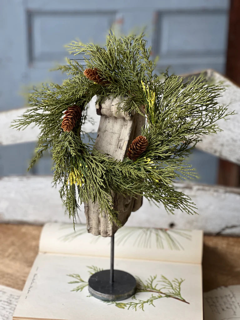 Candle ring displayed on an antique spindle.