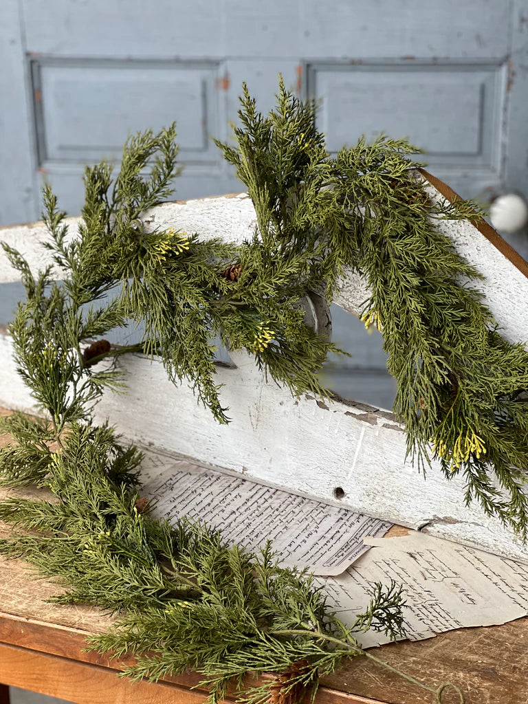 Greenery on a wooden surface with a rustic background